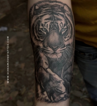 Detailed tiger realism portrait tattoo on forearm featuring lifelike eyes, textured fur, and black and grey shading by Screamzonetattoo Mumbai