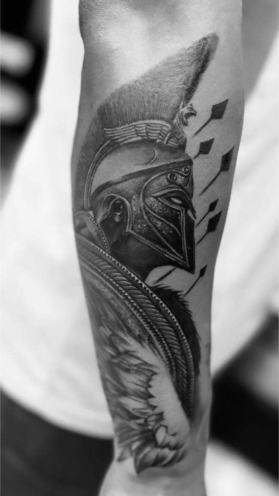 Warrior portrait tattoo with in detailed black and grey realism style on upper body